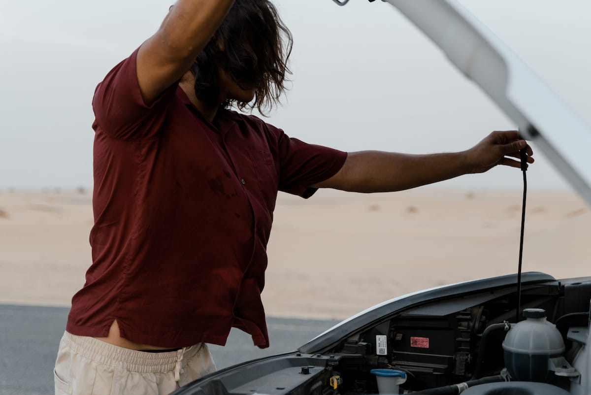Mobile mechanic working on a car in the Mojave desert sun near Twentynine Palms California